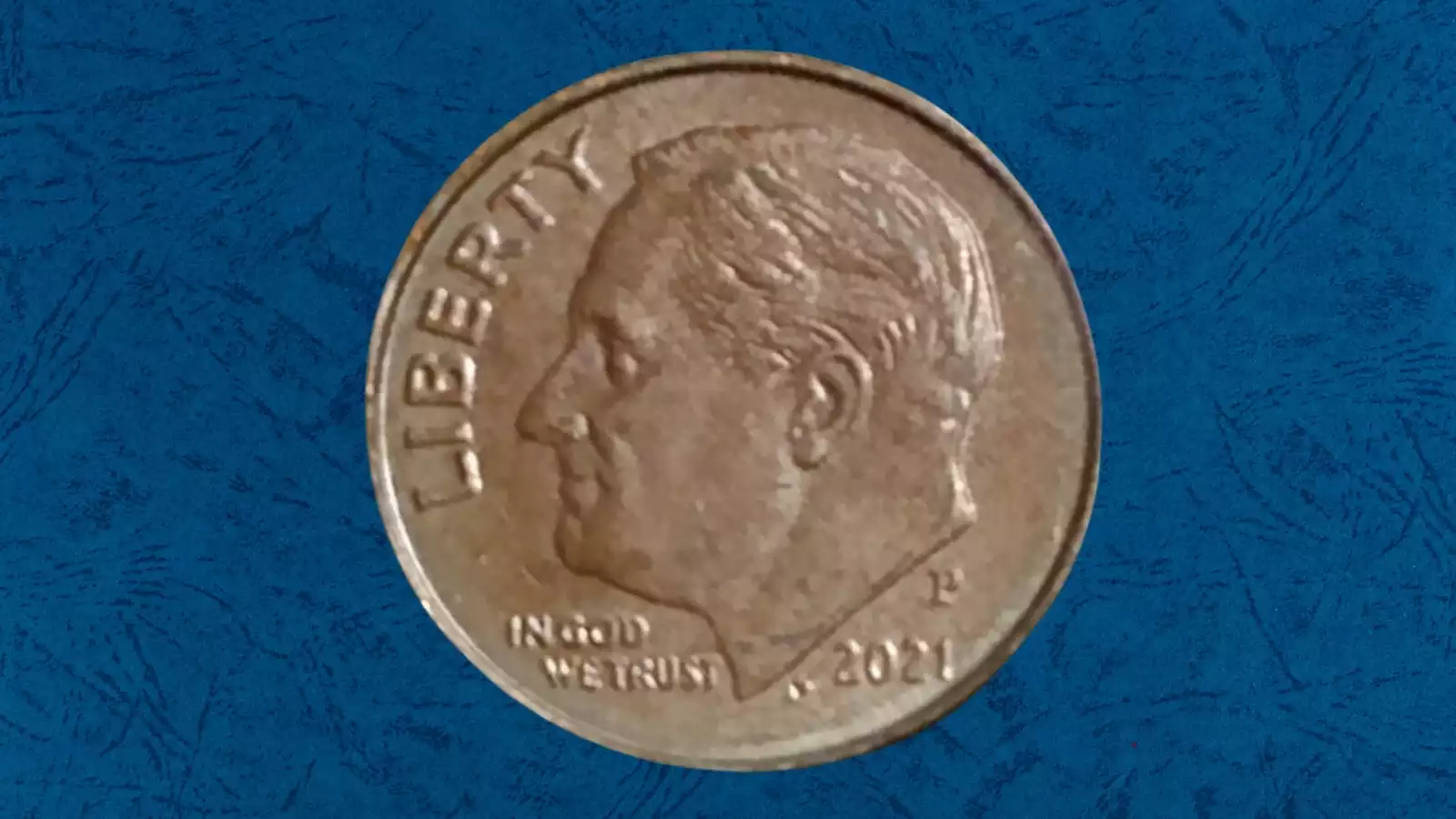 2021 Roosevelt dime missing clad layer error showing exposed copper-colored core on one face
